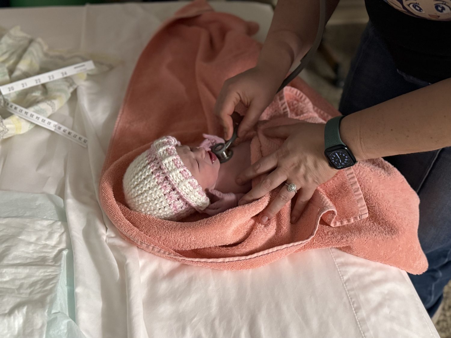 Midwife caring for a newborn during a visit